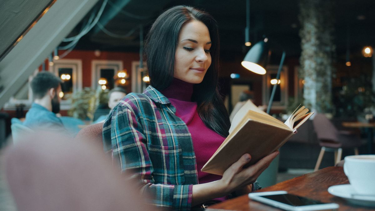 woman studying at a cafe table