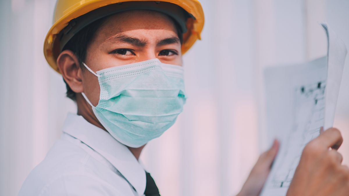 construction site manager checking blueprint