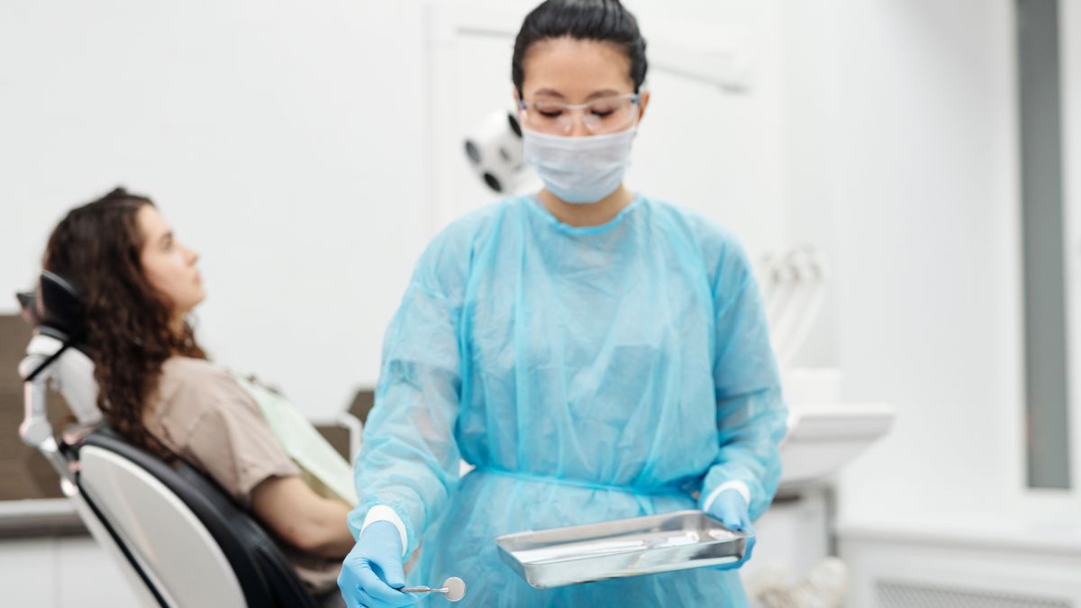 dental assistant preparing instruments in clinic