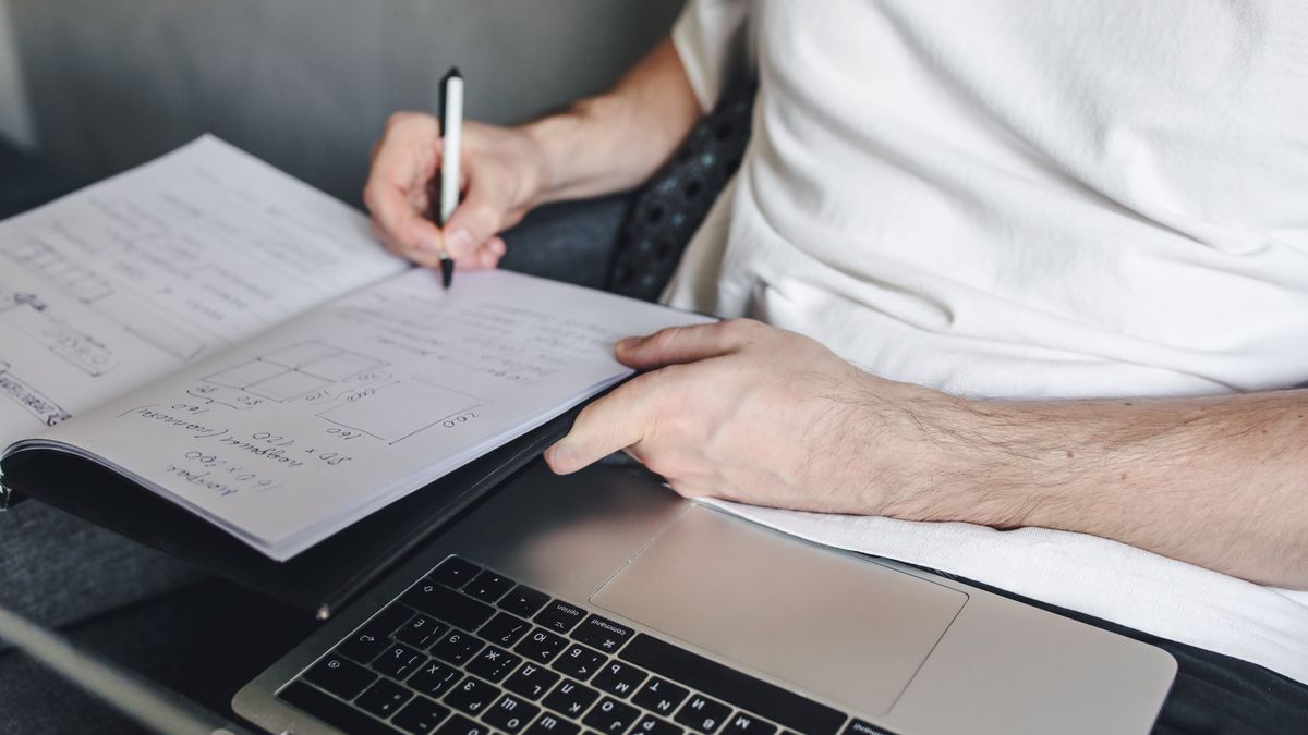 engineer studying at desk with notebook