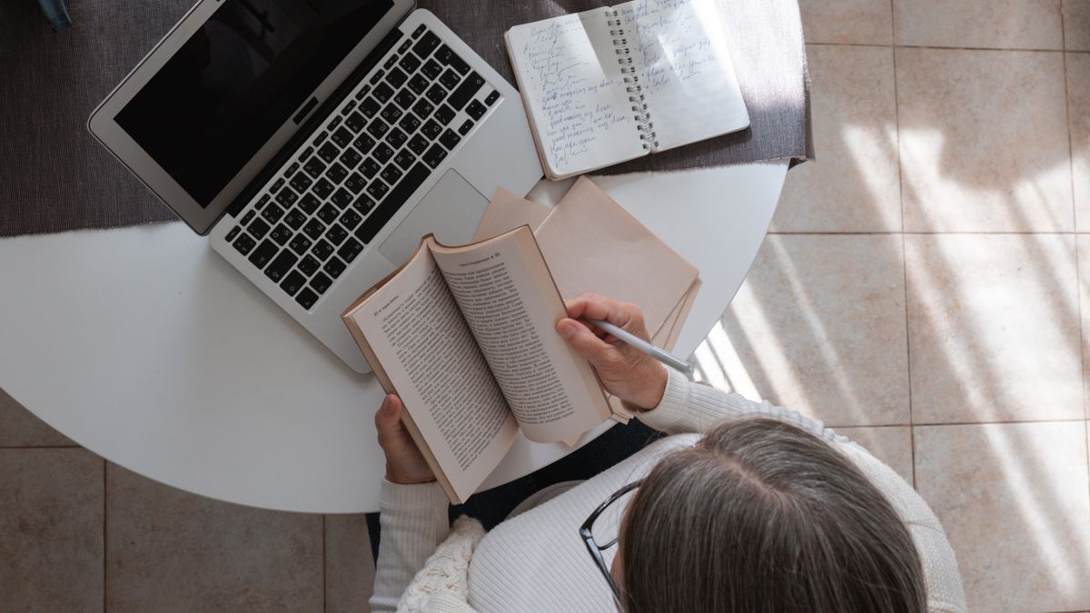 woman studying at home with notebook