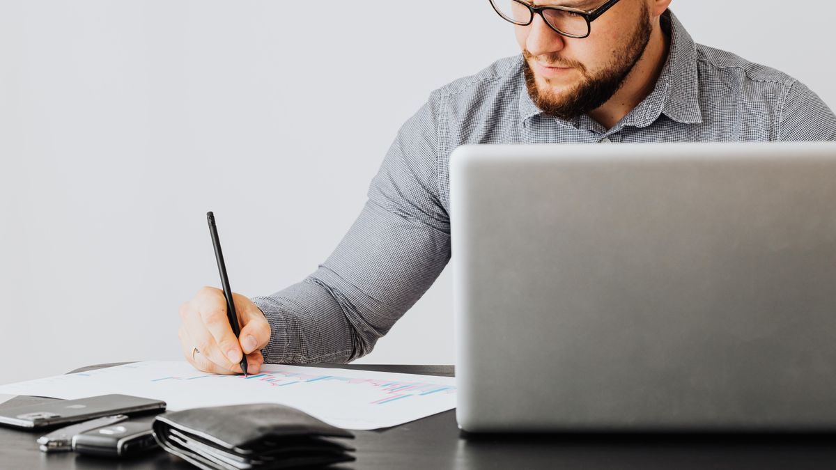 office worker studying laptop notes