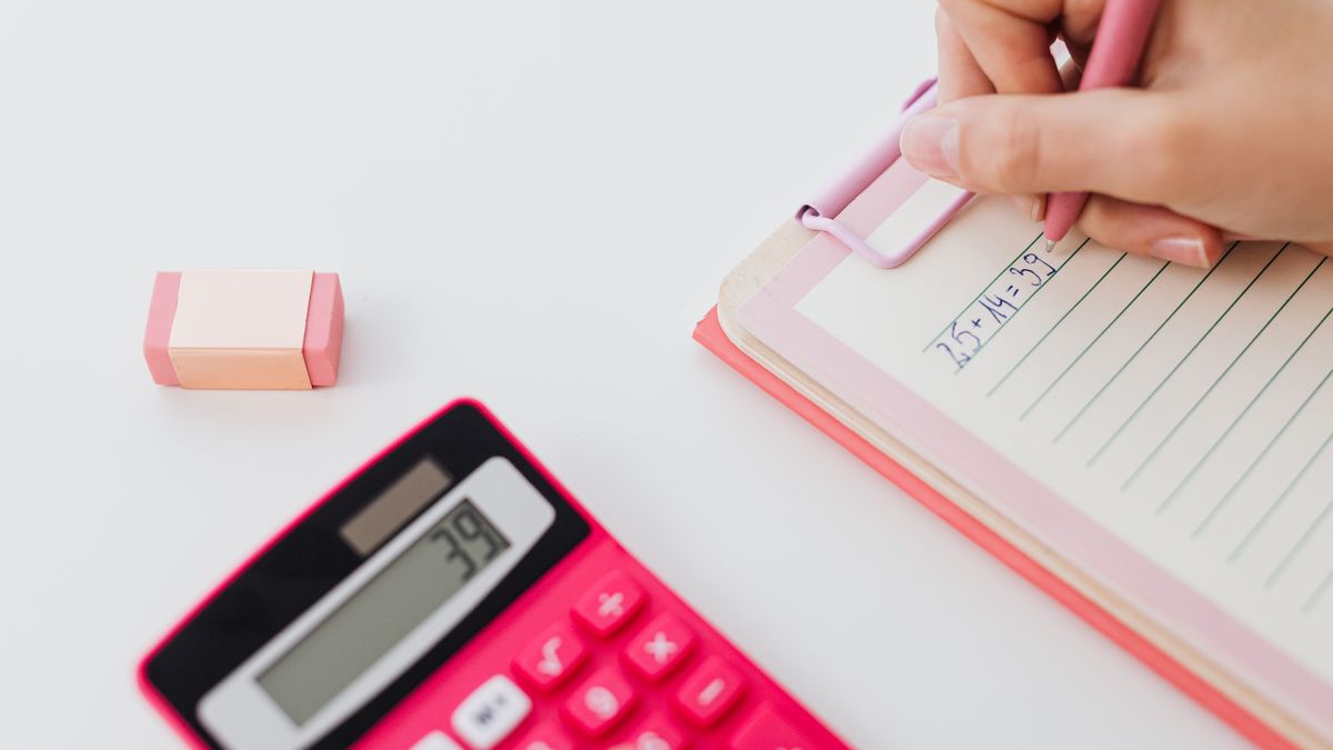 person studying with calculator notebook