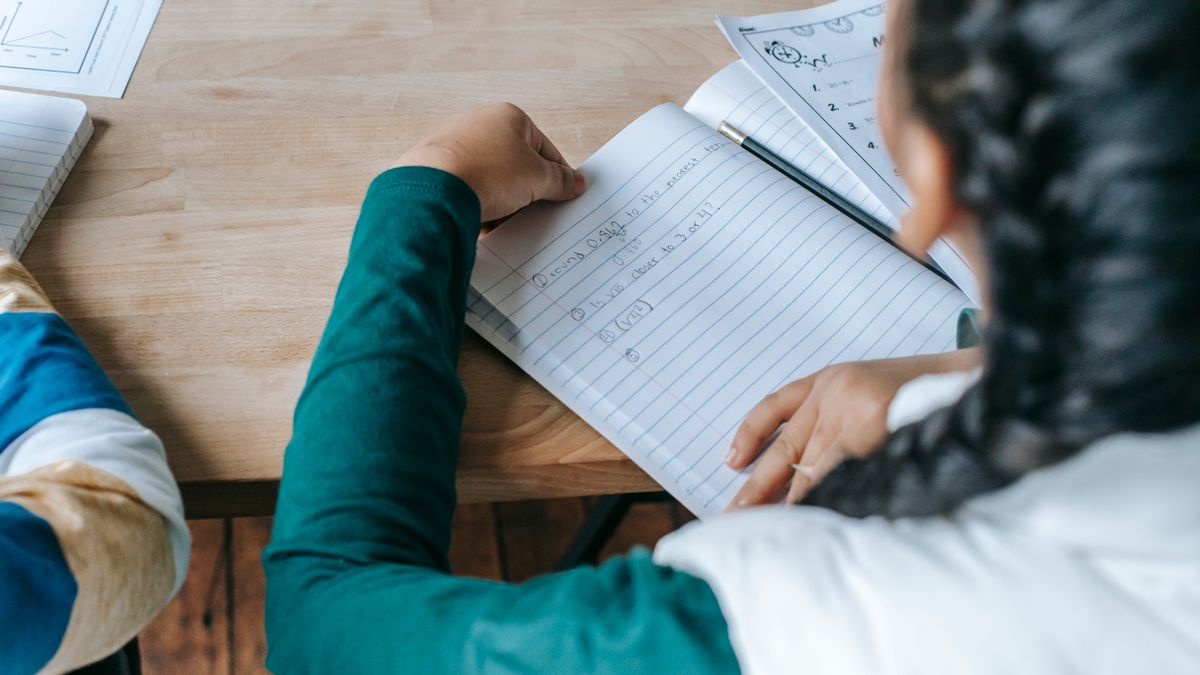 person studying weather textbook at desk