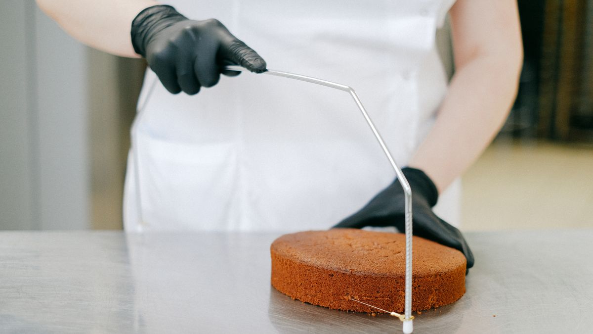 pastry chef decorating cake in bakery