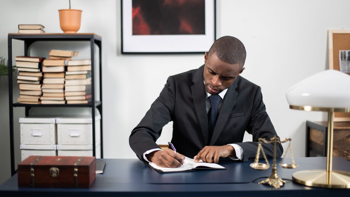 office worker studying real estate law textbook at desk