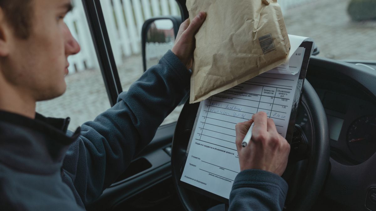 dispatcher checking truck driver at morning roll call