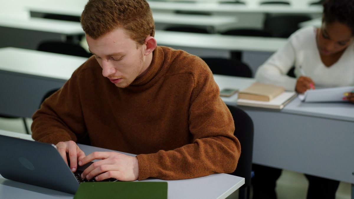 student studying with laptop, notebook, calendar