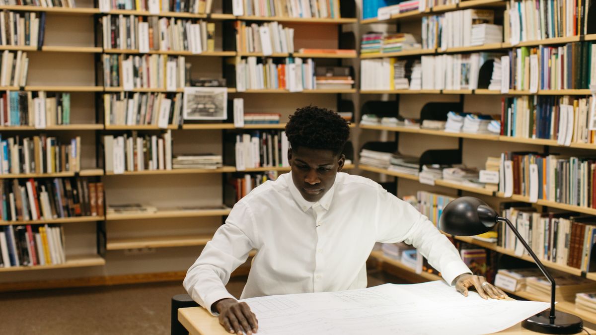 architect studying blueprints at desk