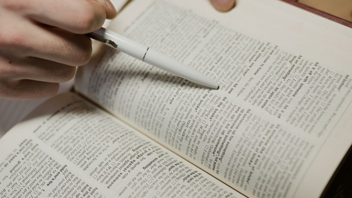person highlighting notes in textbook