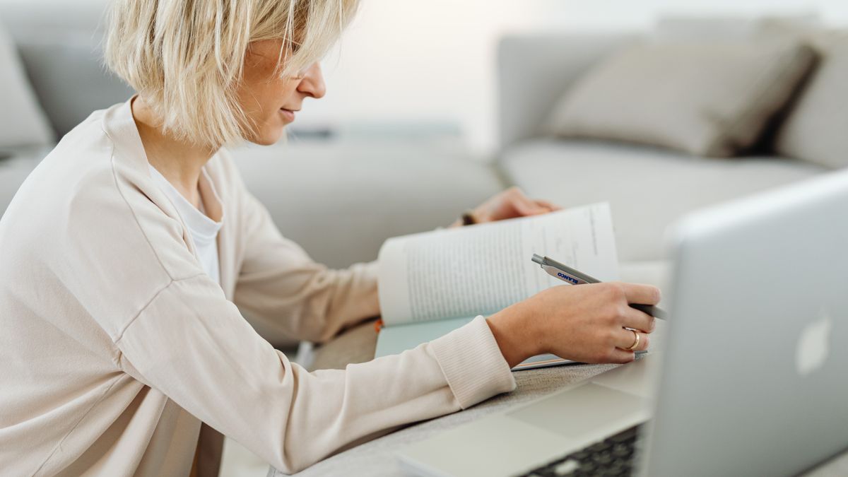 woman studying at home with notebook