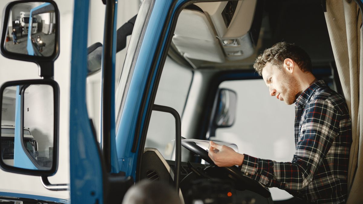 dispatcher checking truck driver before departure