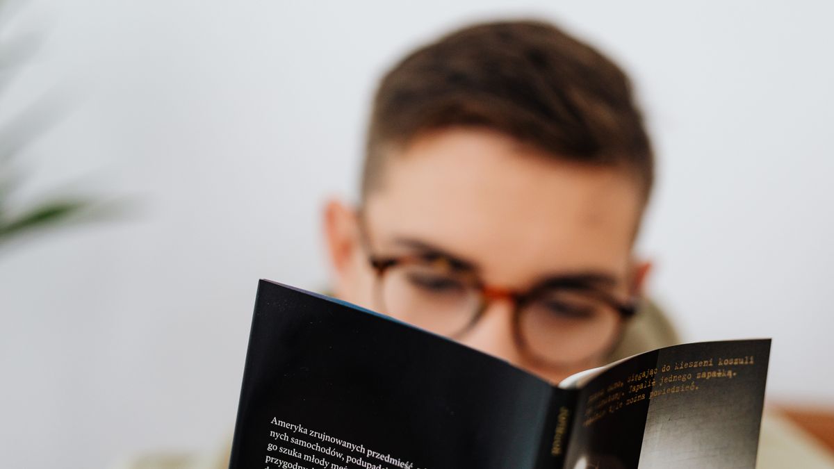 person studying textbook at night
