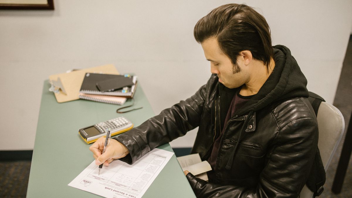 person taking exam on computer in test center