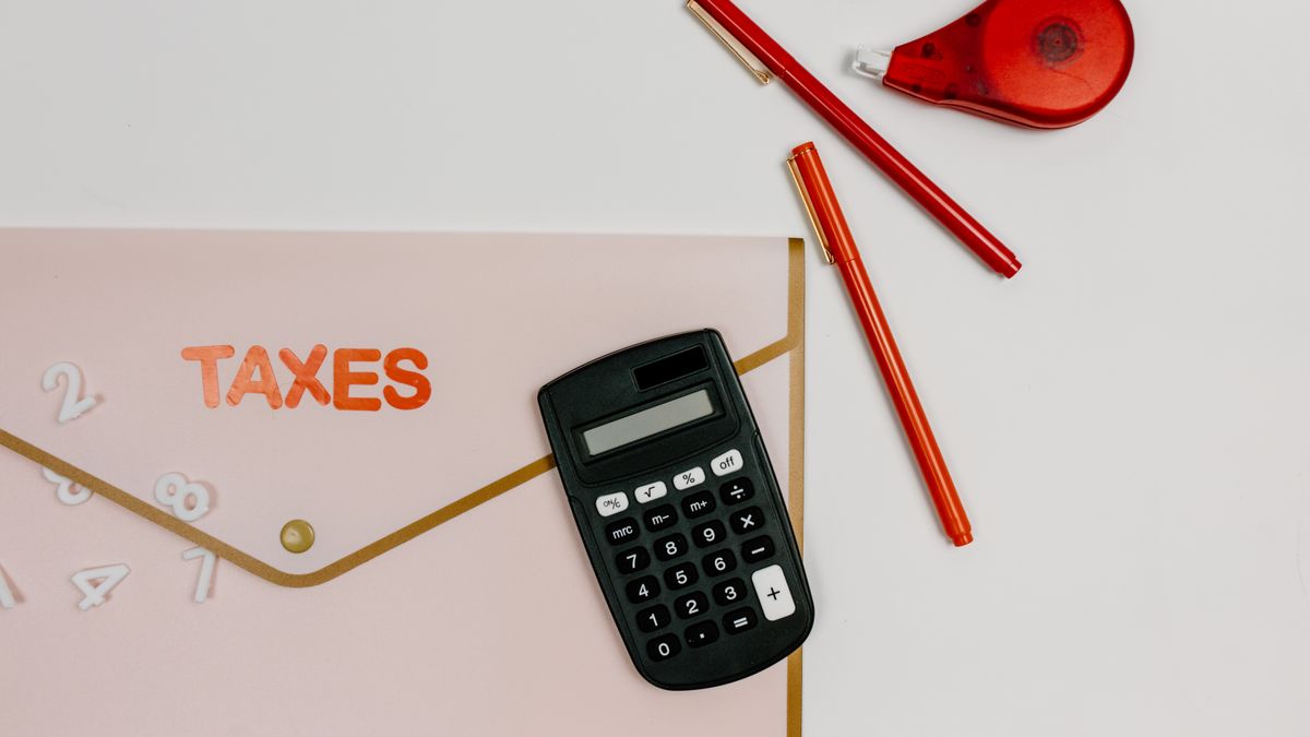 calculator with tax documents on office desk