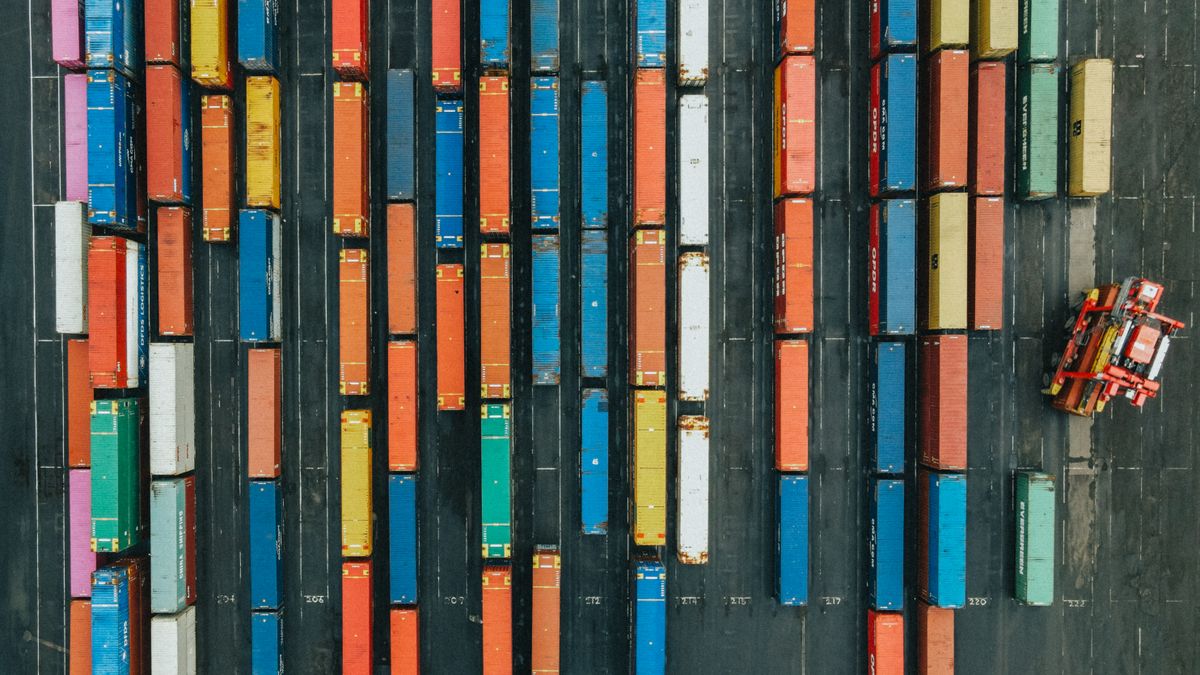 shipping containers stacked at port terminal