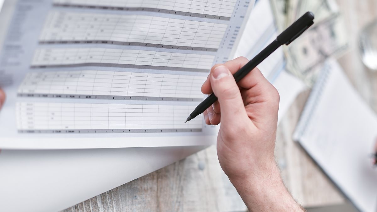accountant reviewing financial documents at office desk