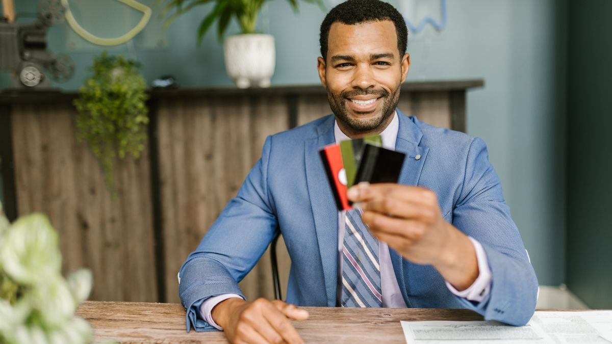 person holding identification card at office desk