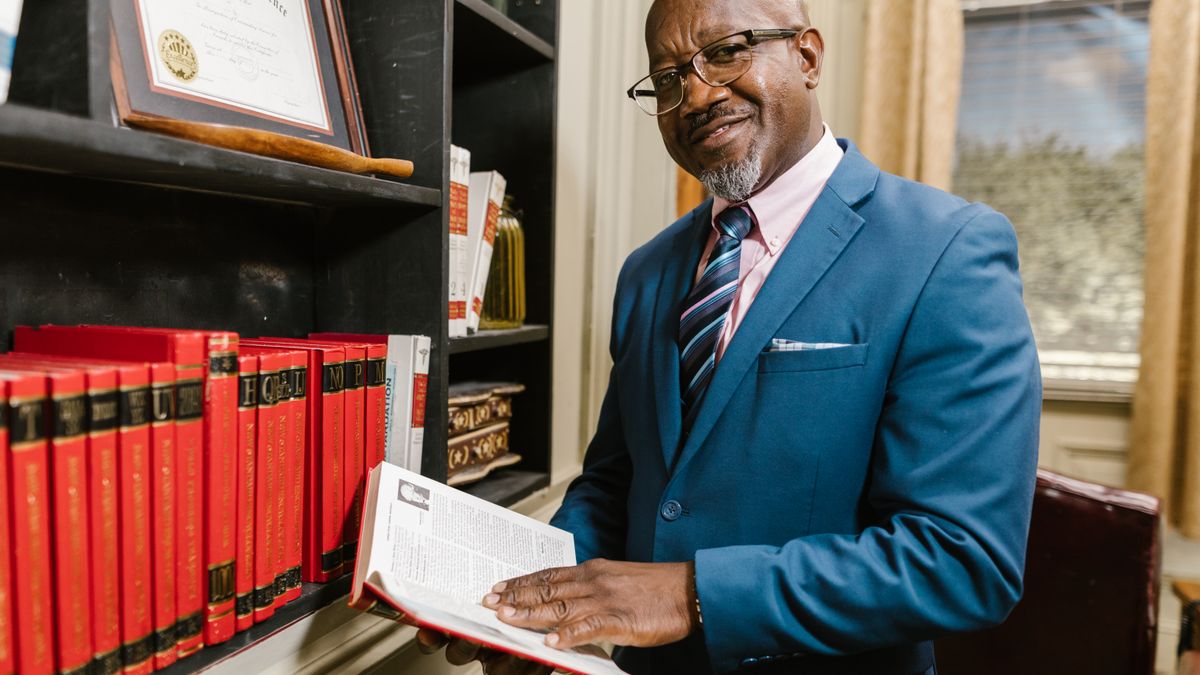 person reading law book at library