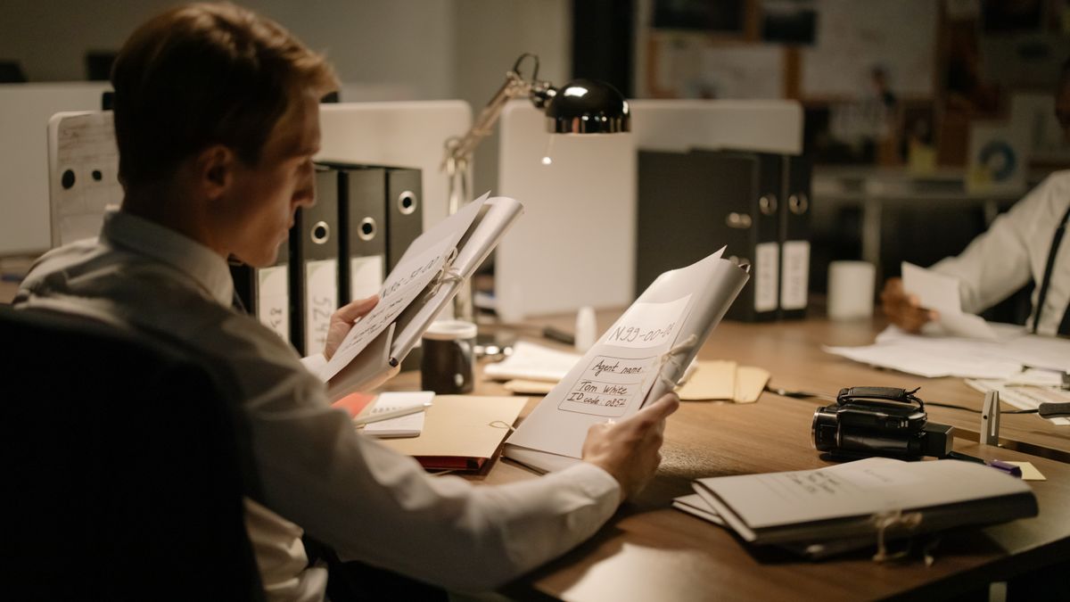 office worker studying law textbook at desk