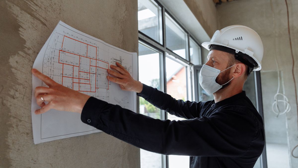 construction site manager checking blueprint