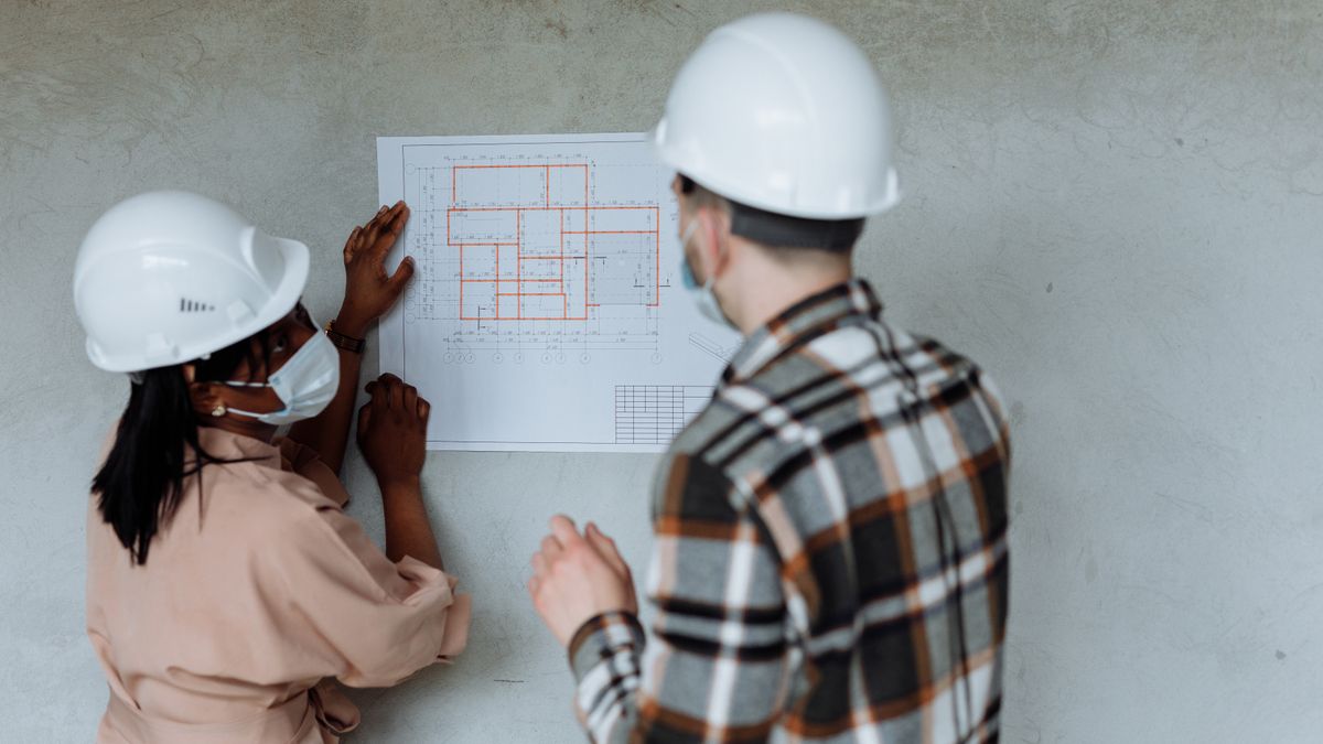 architect reviewing blueprints in office