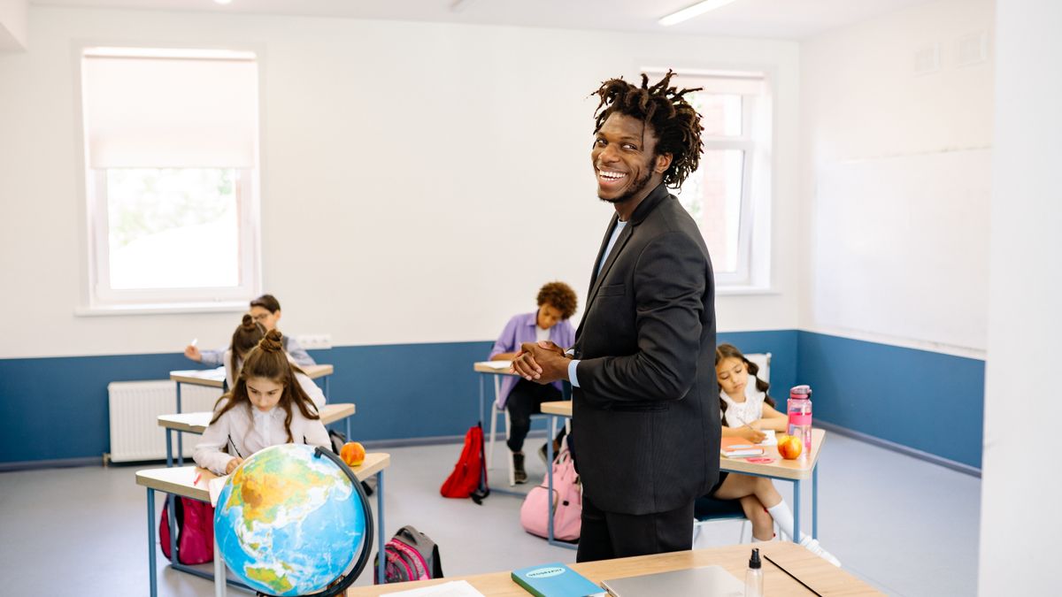 teacher preparing lesson notes at desk