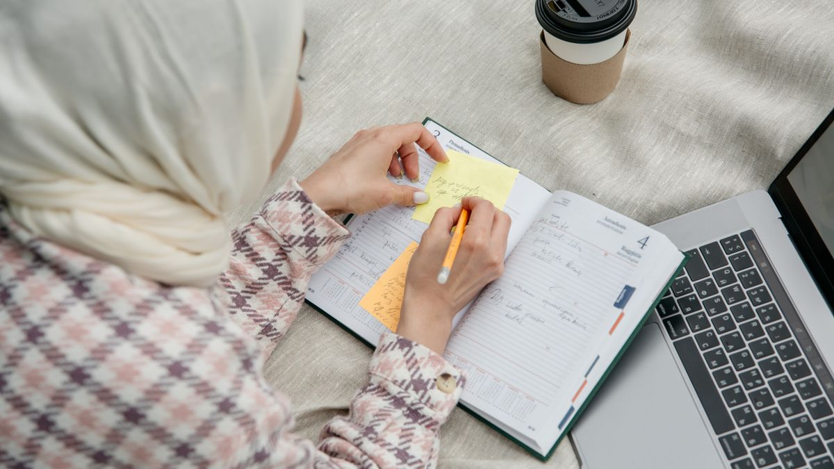person studying with laptop notebook