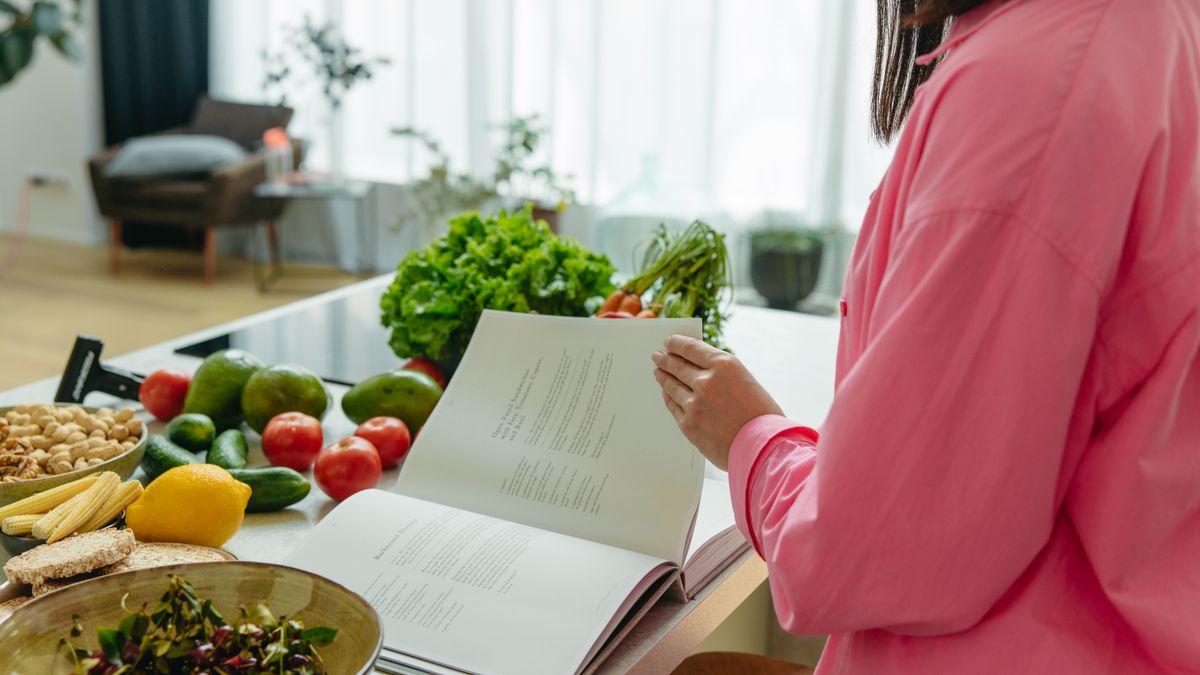 chef reading textbook in kitchen